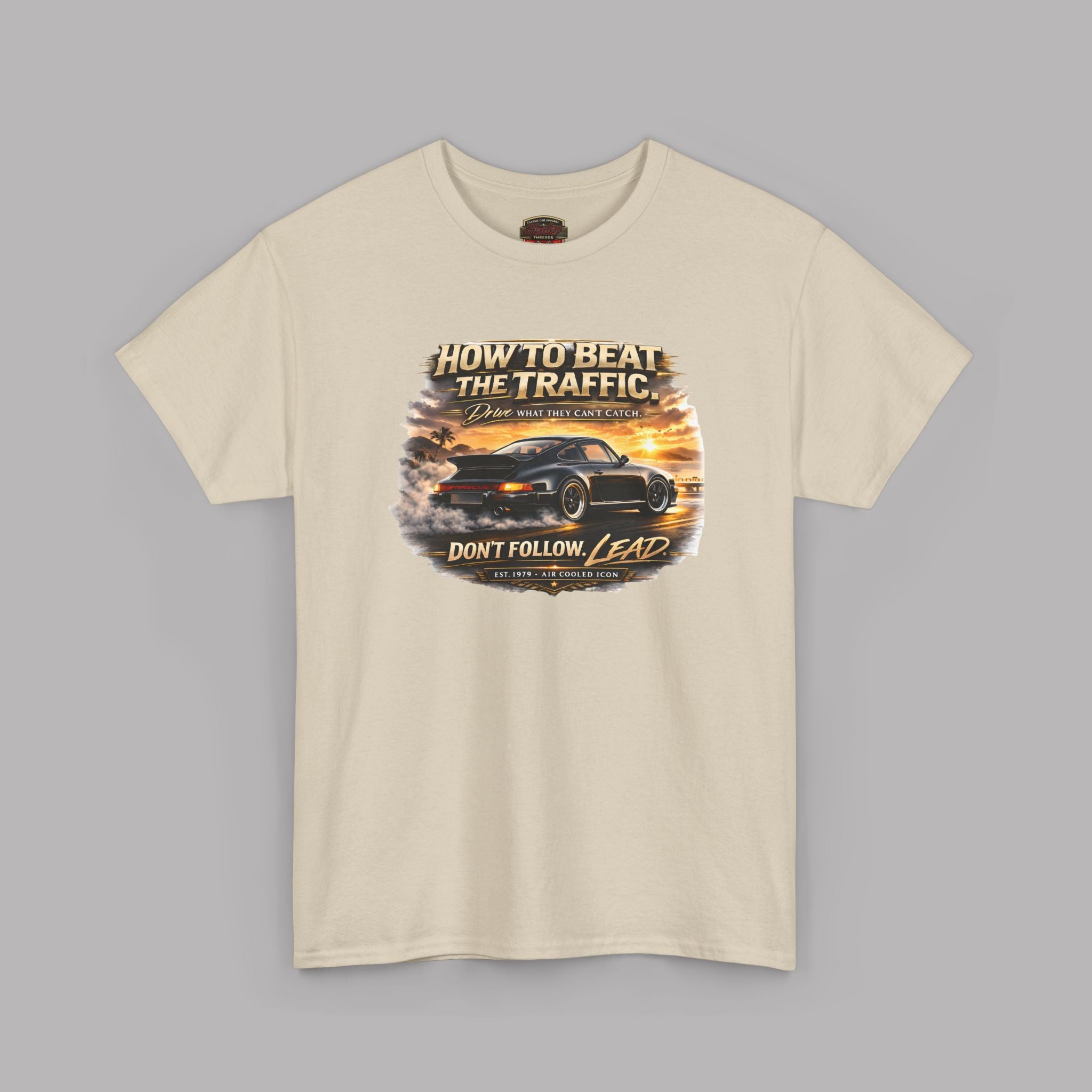 Sand t-shirt with a graphic design of a classic car and text on a gray background