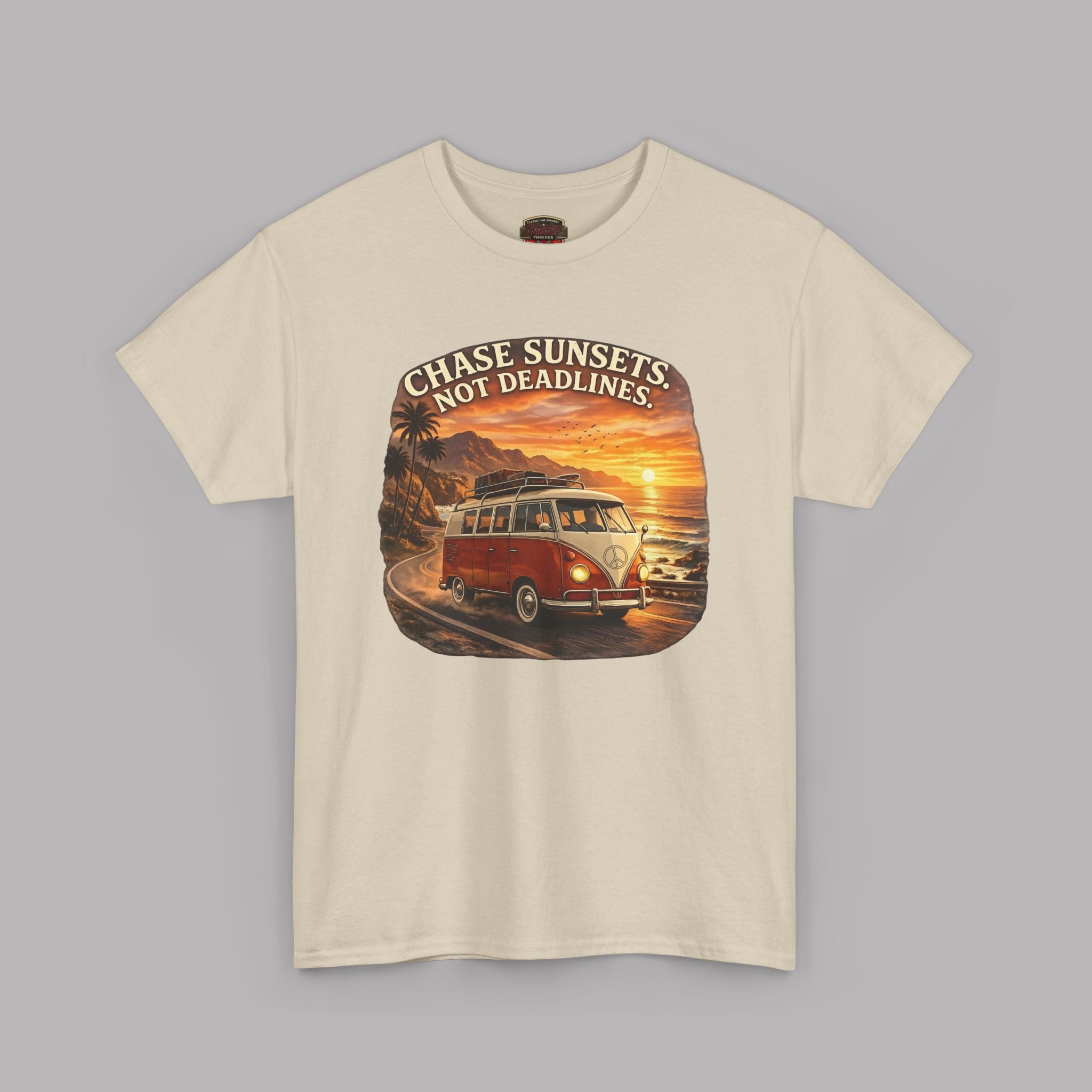 Sand t-shirt with a graphic of a classic van and sunset text on a gray background