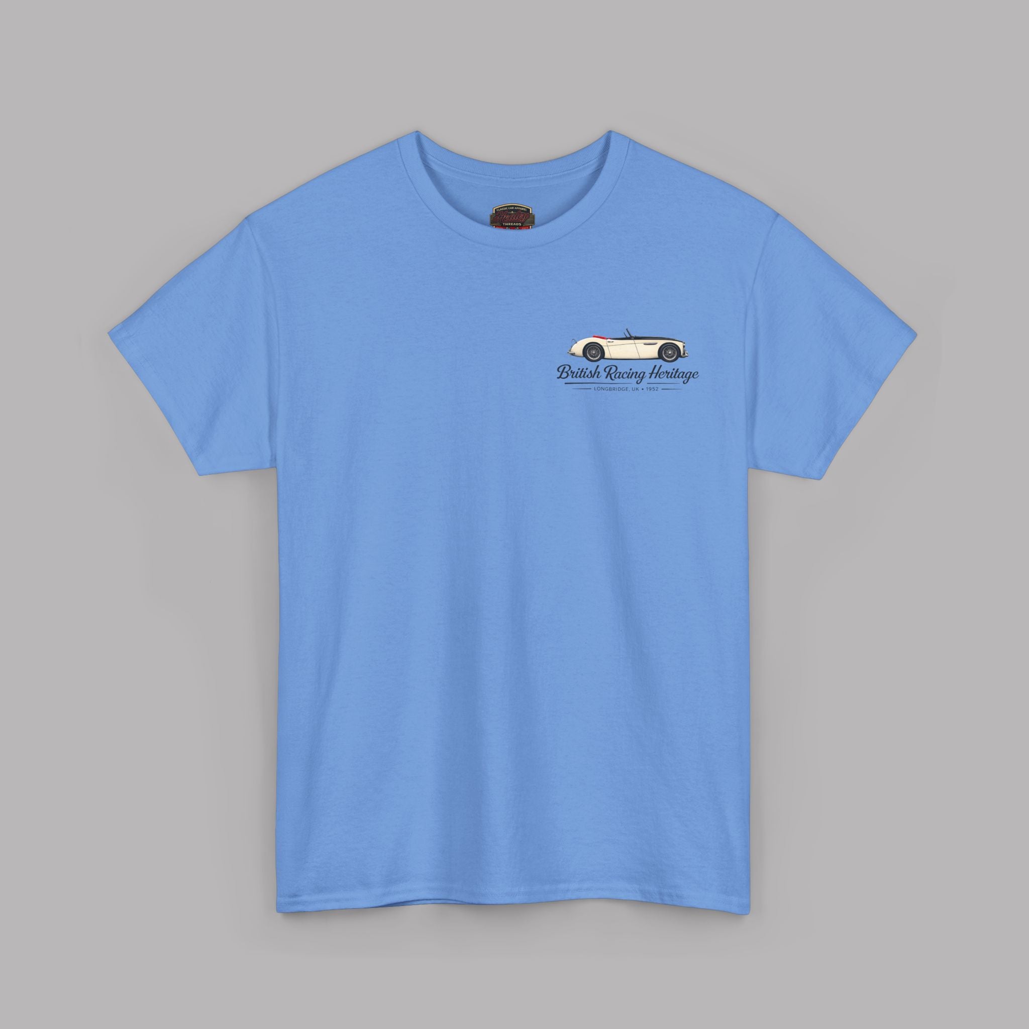 Front of a blue t-shirt with a Healey classic car graphic design on a gray background