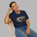 Woman wearing a navy blue t-shirt with 'Drive It. Don't Park It and vintage car graphic.