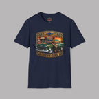 A navy blue short-sleeve t-shirt with a vintage-style graphic on the chest featuring a green 1955 Chevy truck, a woman, and the text 'CHEVY GIRL' and '1955'. A small Chevrolet bowtie logo is visible inside the collar.