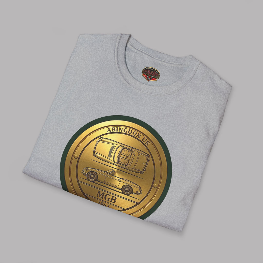 Folded gray t-shirt with a gold and green emblem featuring a classic car on a gray background