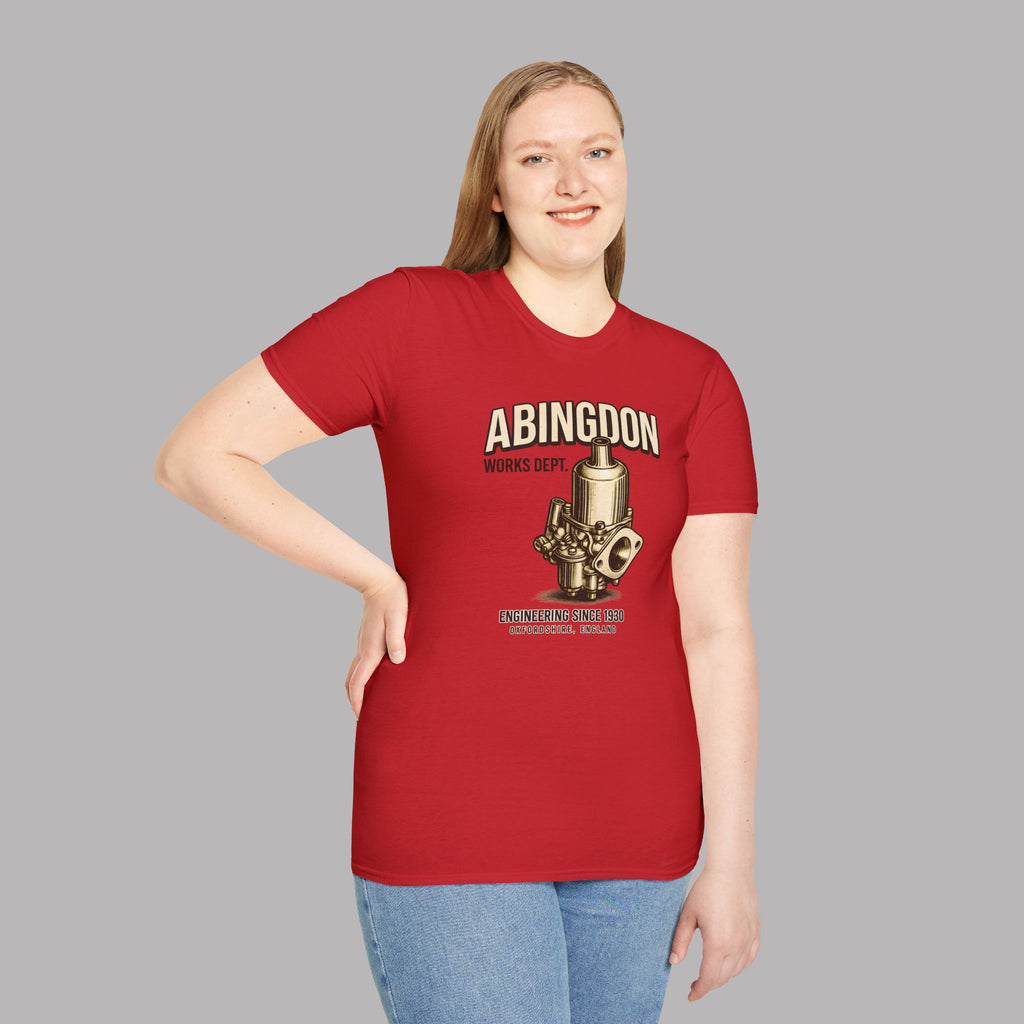 Woman wearing a red t-shirt with a 'Abingdon Works Dept.' graphic design on a gray background