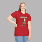 Woman wearing a red t-shirt with a 'Abingdon Works Dept.' graphic design on a gray background