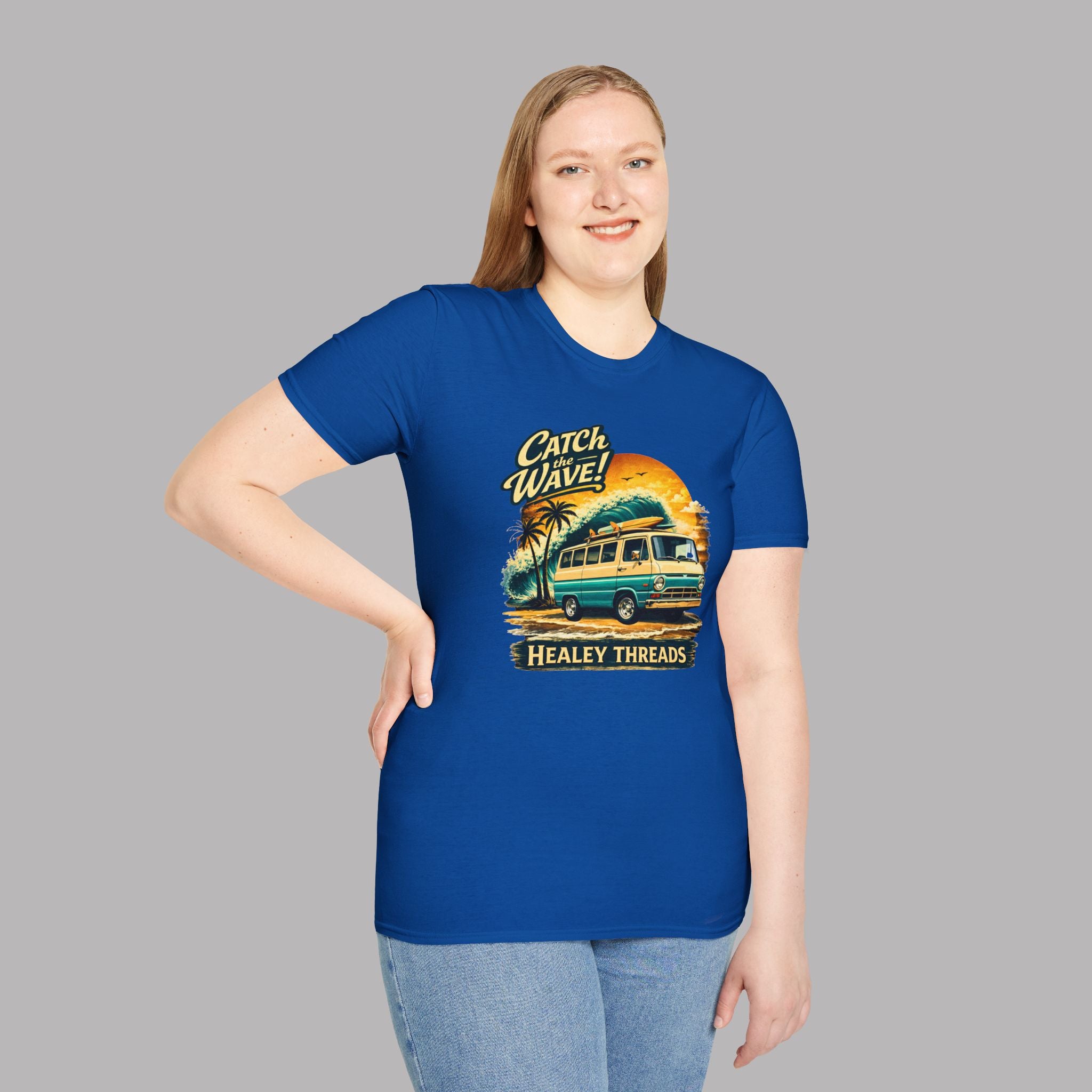 Woman wearing a royal blue t-shirt with a graphic classic van design and text on a gray background