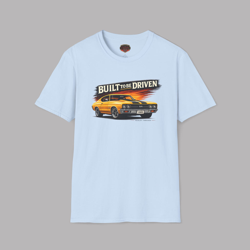 Light blue t-shirt with a graphic of a yellow car and 'Built to be Driven' text on a gray background