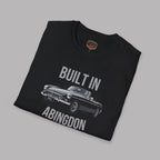 Folded black t-shirt with a classic car graphic and text 'Built in Abingdon' on a gray background
