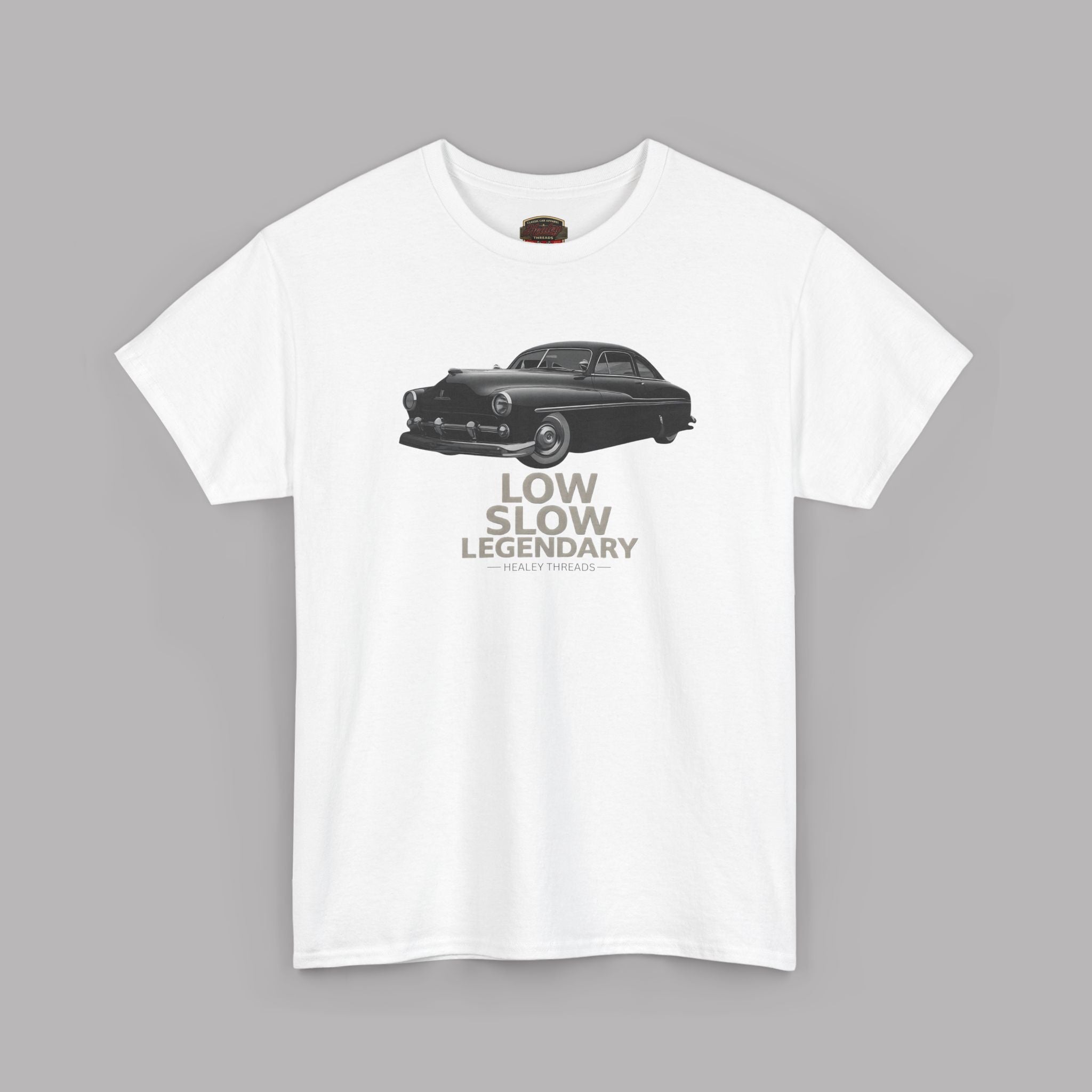 White t-shirt with a graphic of a vintage car and text 'Low Slow Legendary' on a gray background