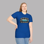 Woman wearing a royal blue t-shirt with a graphic and text on a gray background