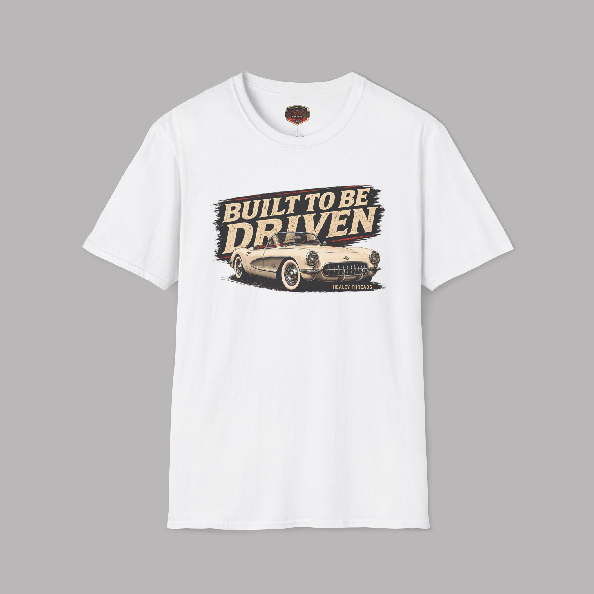 White t-shirt with 'Built to be Driven' graphic on a gray background