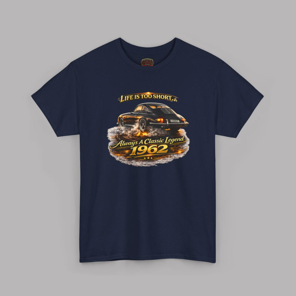 A navy blue short-sleeve t-shirt with a graphic print of a classic car and the text 'Life is too short to 1962 Always be a Classic Legend' on a solid gray background.