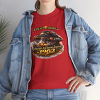 A woman wearing a red graphic t-shirt with a black car print and the text 'LIFE IS TOO SHORT. Always A Classic Legend 1962', styled with an open light blue denim jacket.