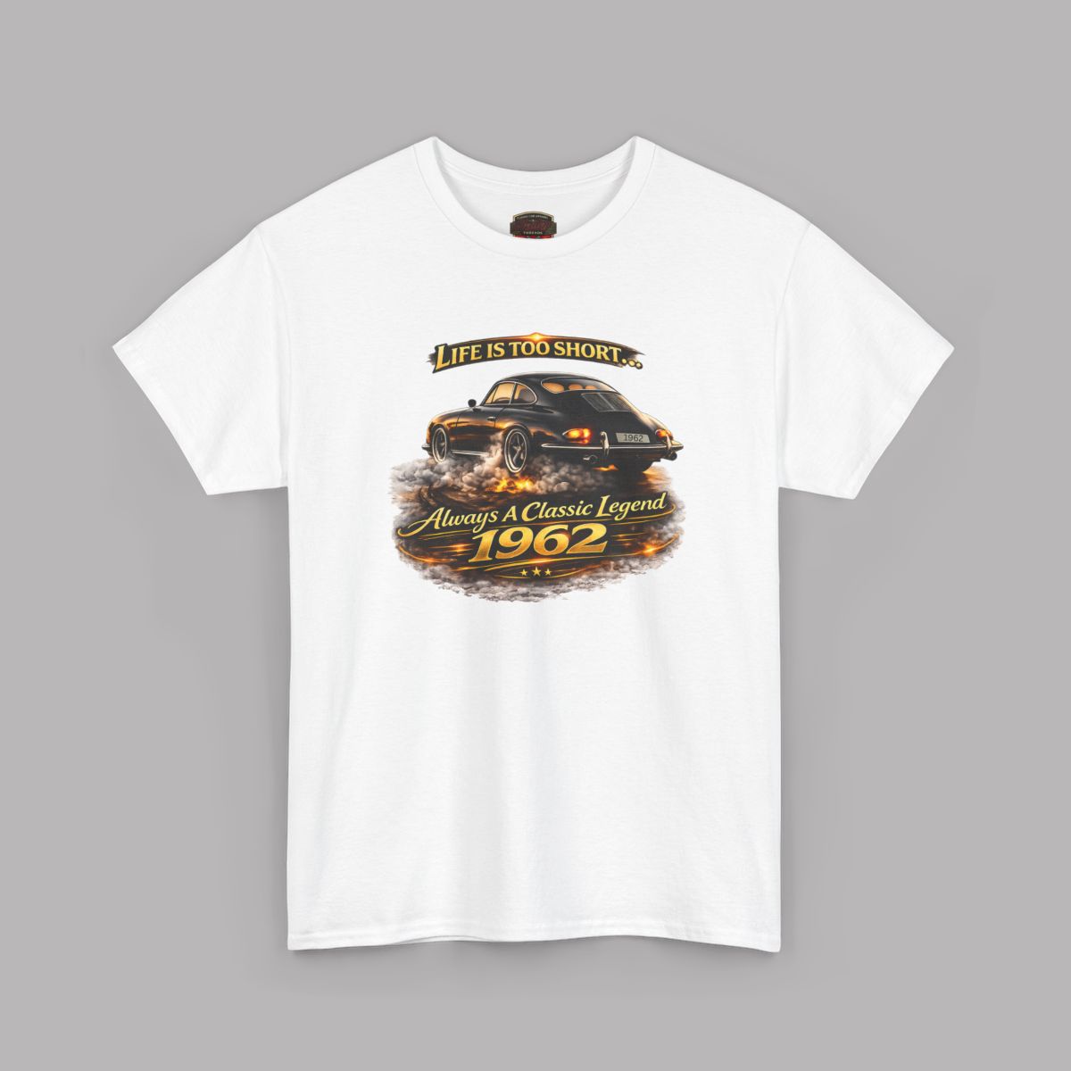 A white short-sleeve crewneck t-shirt with a graphic print of a classic car and the text 'Life is too short. Always a Classic Legend 1962' on a solid gray background.
