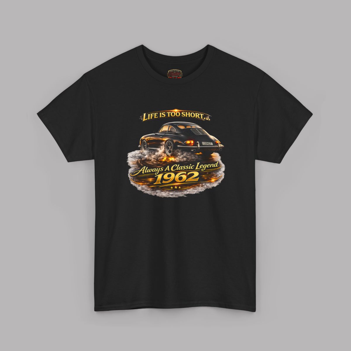 A black short-sleeve crewneck t-shirt featuring a graphic print of a classic car with flames and the text 'Life is too short to be ordinary. Always be a classic legend 1962'.