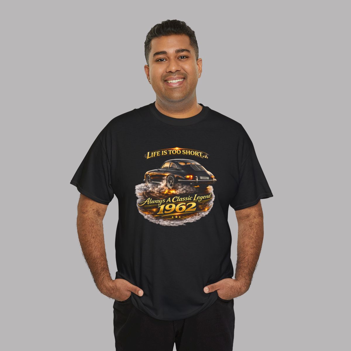 Man wearing a black short-sleeve t-shirt featuring a graphic print of a classic car with flames and the text 'Life is too short to be ordinary. Always be a classic legend 1962'.