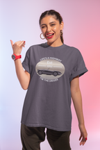 Woman wearing a gray t-shirt with a graphic design on a gradient background