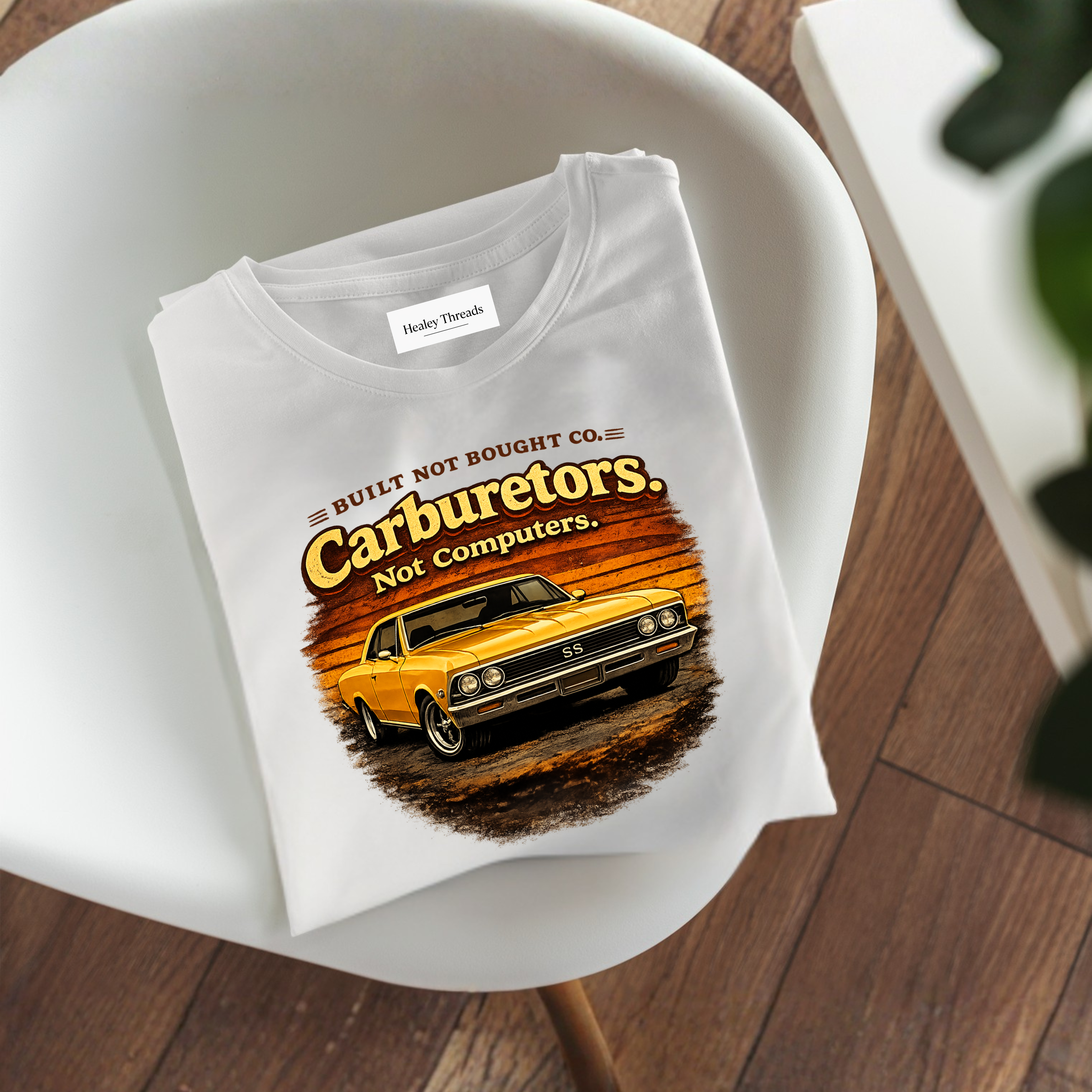 Folded t-shirt with a graphic design on a white chair