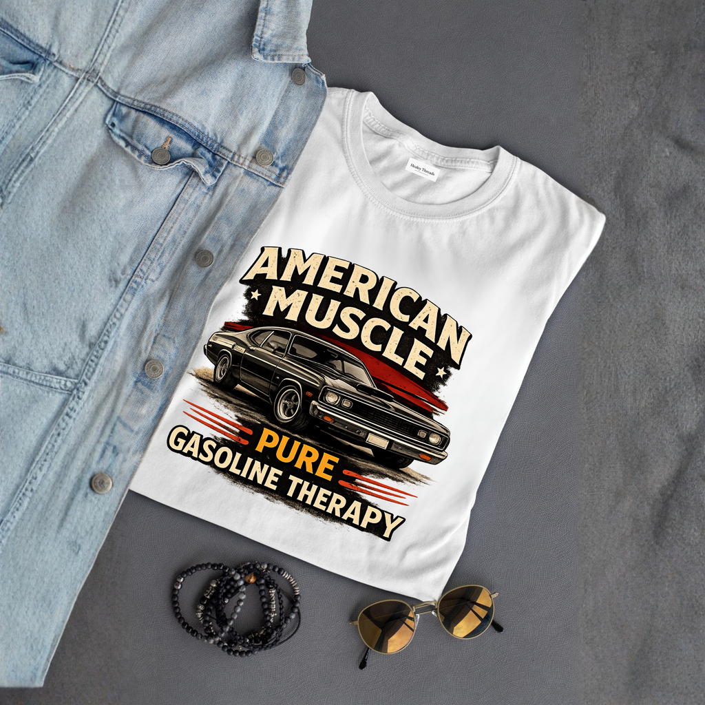 White t-shirt with 'American Muscle' graphic design on a gray surface with denim jacket, sunglasses, and bracelets.