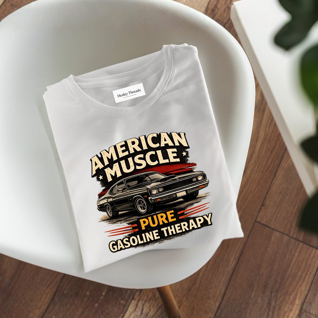 Folded t-shirt with 'American Muscle' graphic design on a white chair.