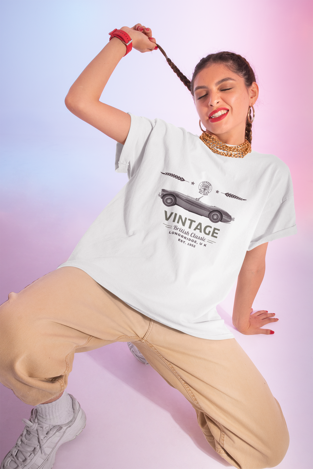 Woman wearing a white t-shirt with vintage car graphic and text, posing against a gradient background.