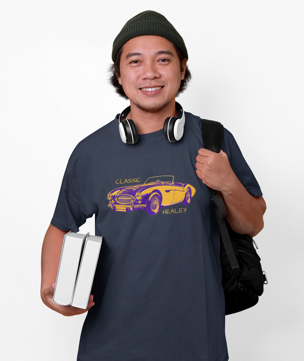 Man wearing a navy t-shirt with a classic car graphic and 'Healey' text, holding books and a backpack.