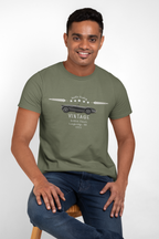 Man wearing a military green t-shirt with a graphic design on a white background