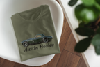Folded military green t-shirt with Austin Healey logo on a white surface