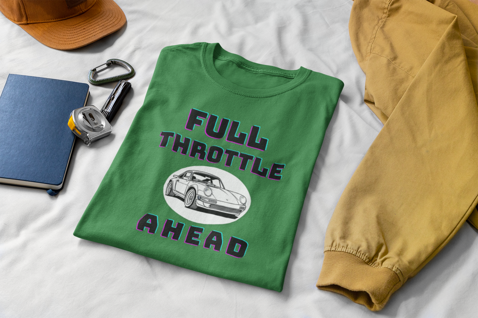 Green t-shirt with 'Full Throttle Ahead' design on a white surface with accessories.