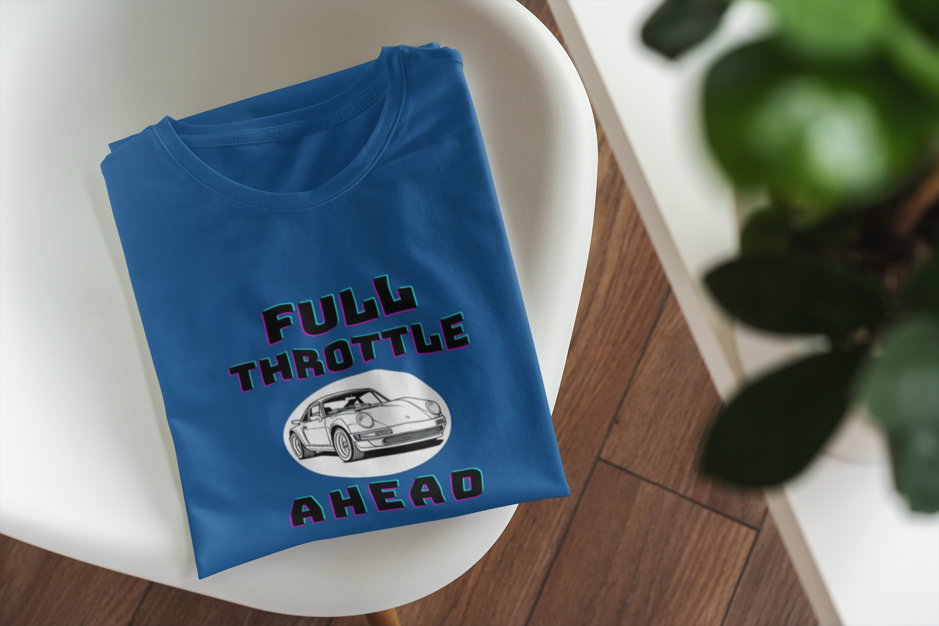 Blue t-shirt with 'Full Throttle Ahead' text and car graphic on a white surface.