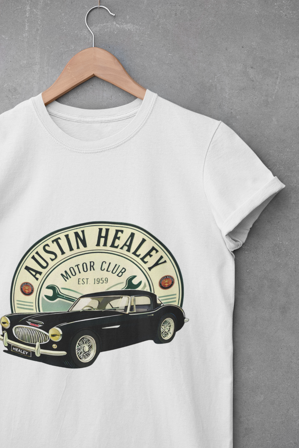 White t-shirt with Austin Healey graphic on a hanger against a gray background