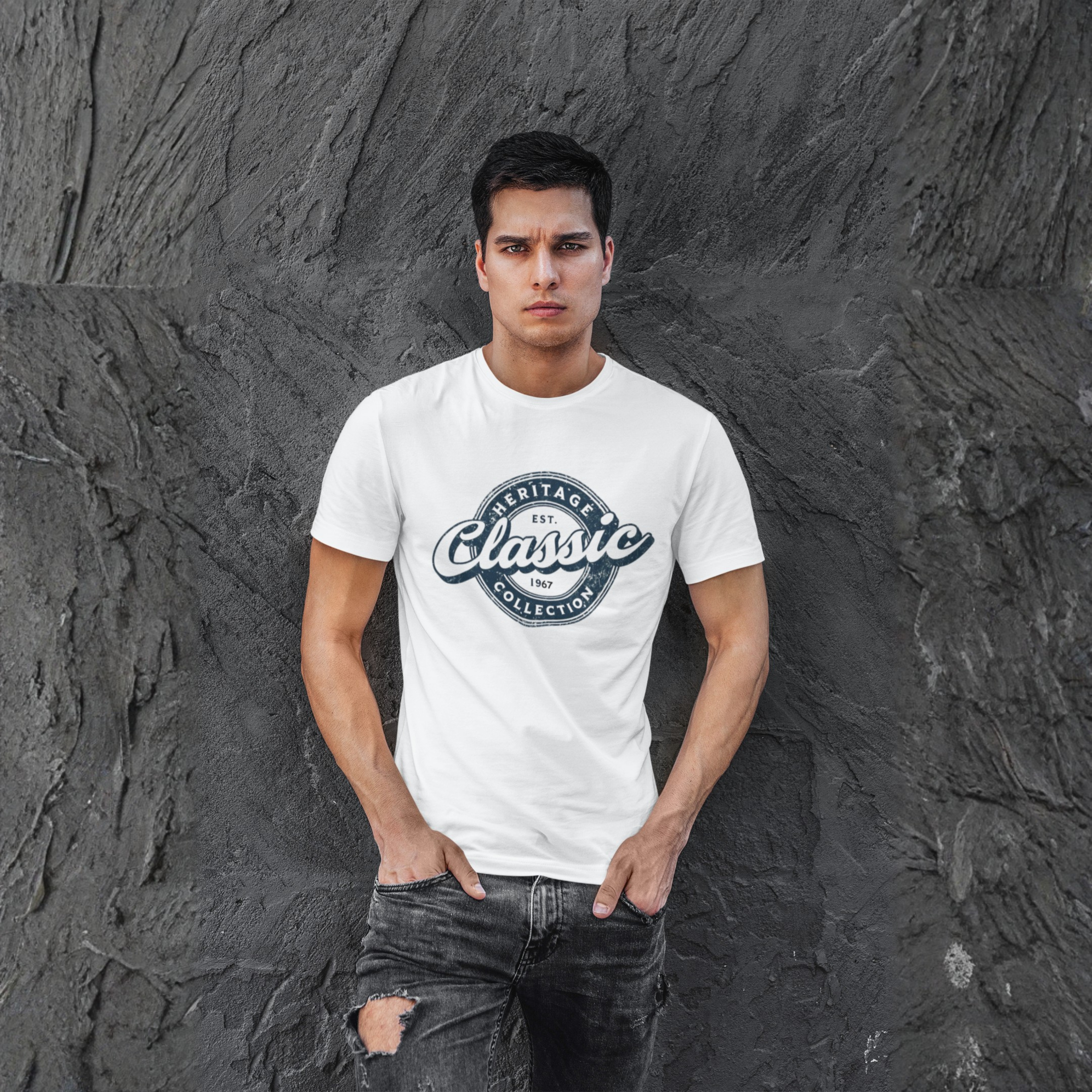 Man wearing a white t-shirt with a logo against a textured gray wall