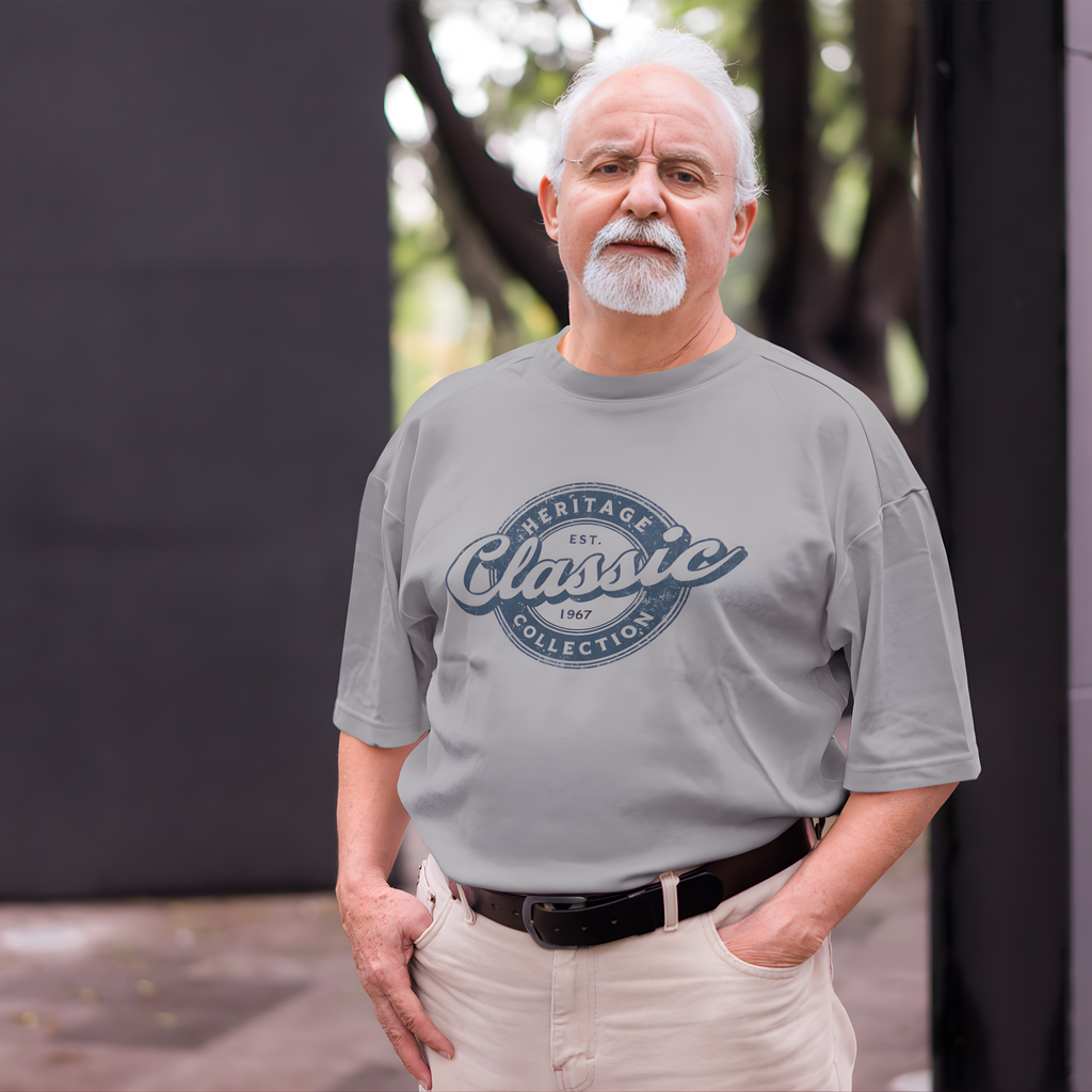 Man wearing a gray t-shirt with 'Heritage Classic Collection' text, standing outdoors.