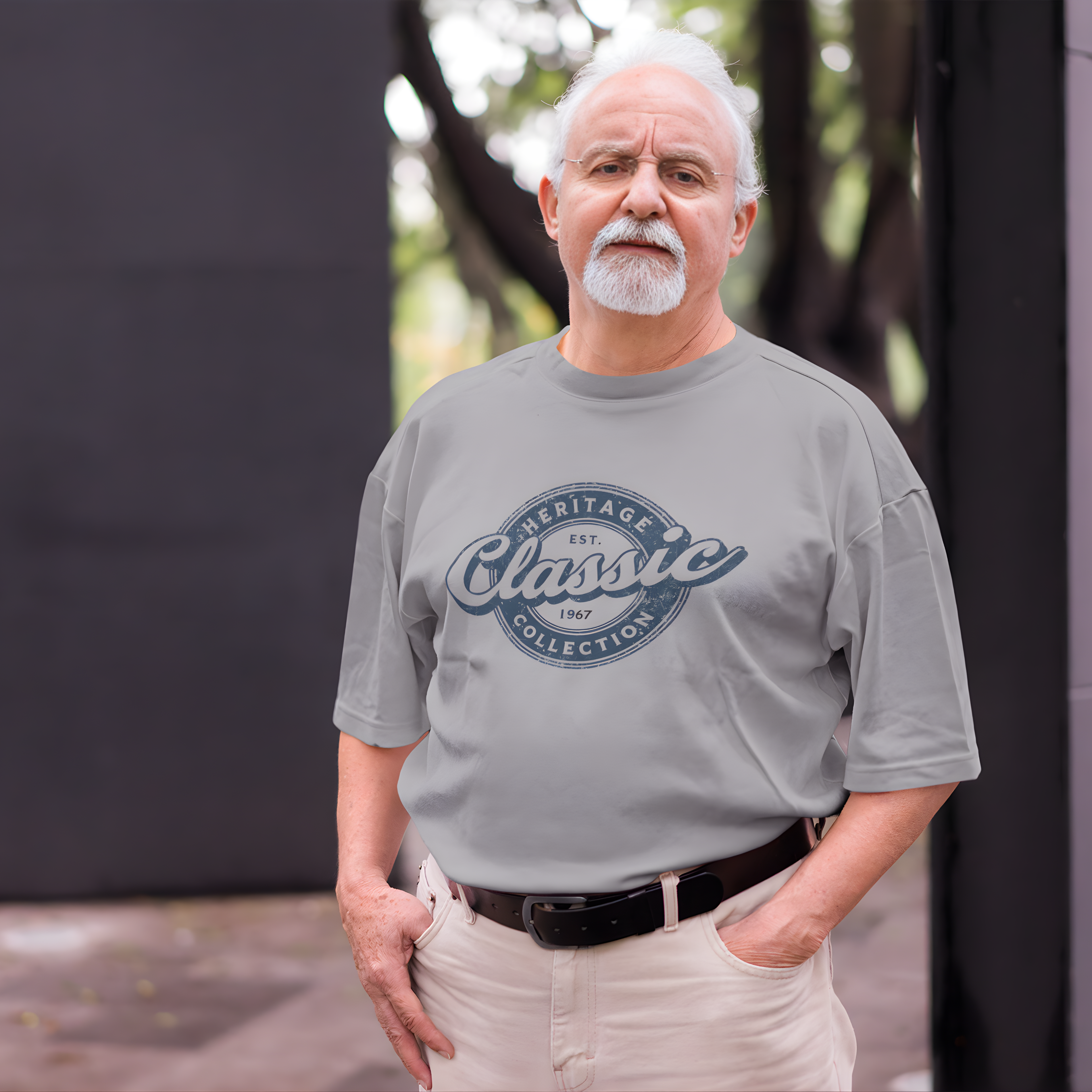 Man wearing a gray t-shirt with 'Heritage Classic Collection' text, standing outdoors.