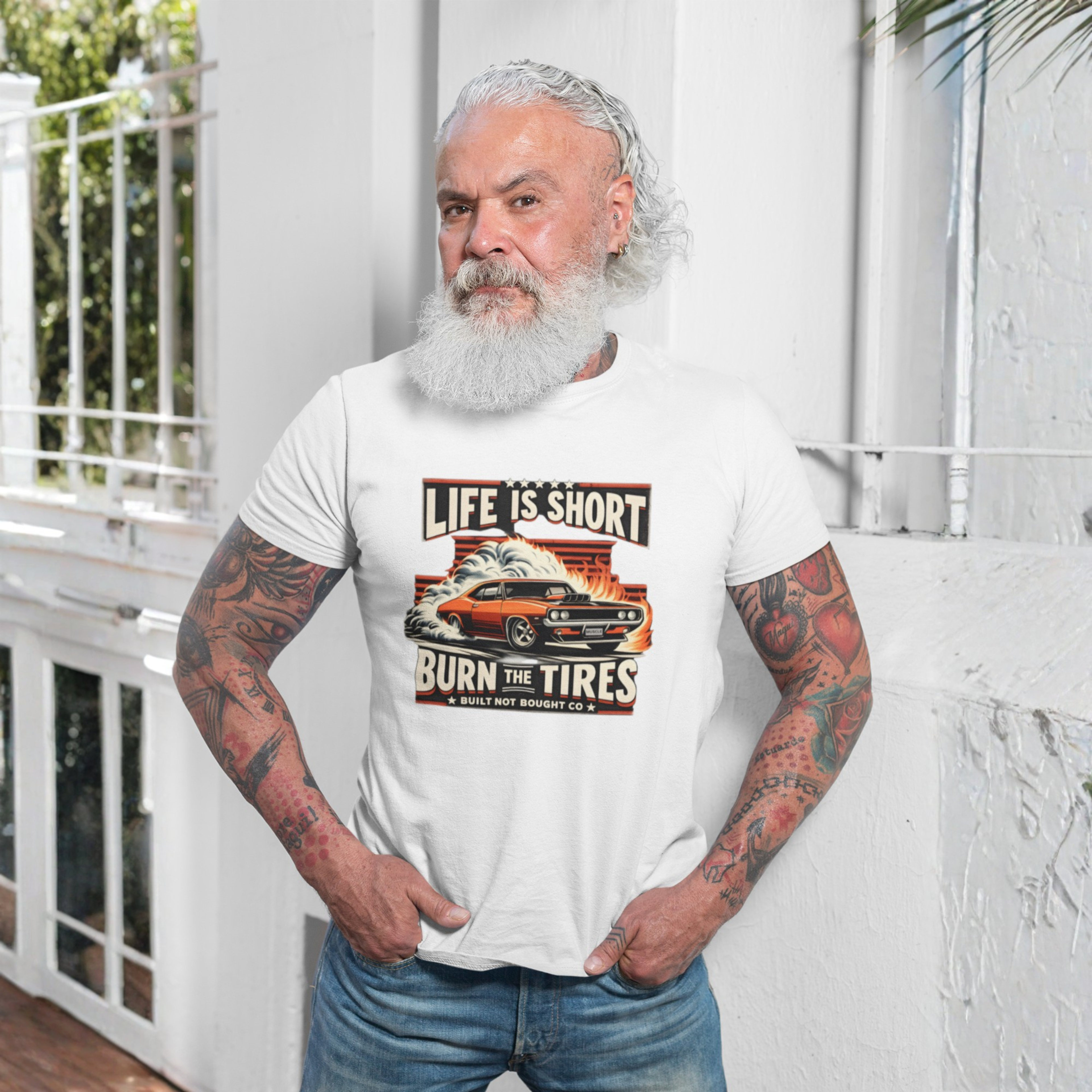 Man wearing a white t-shirt with a graphic design and text, standing outdoors.