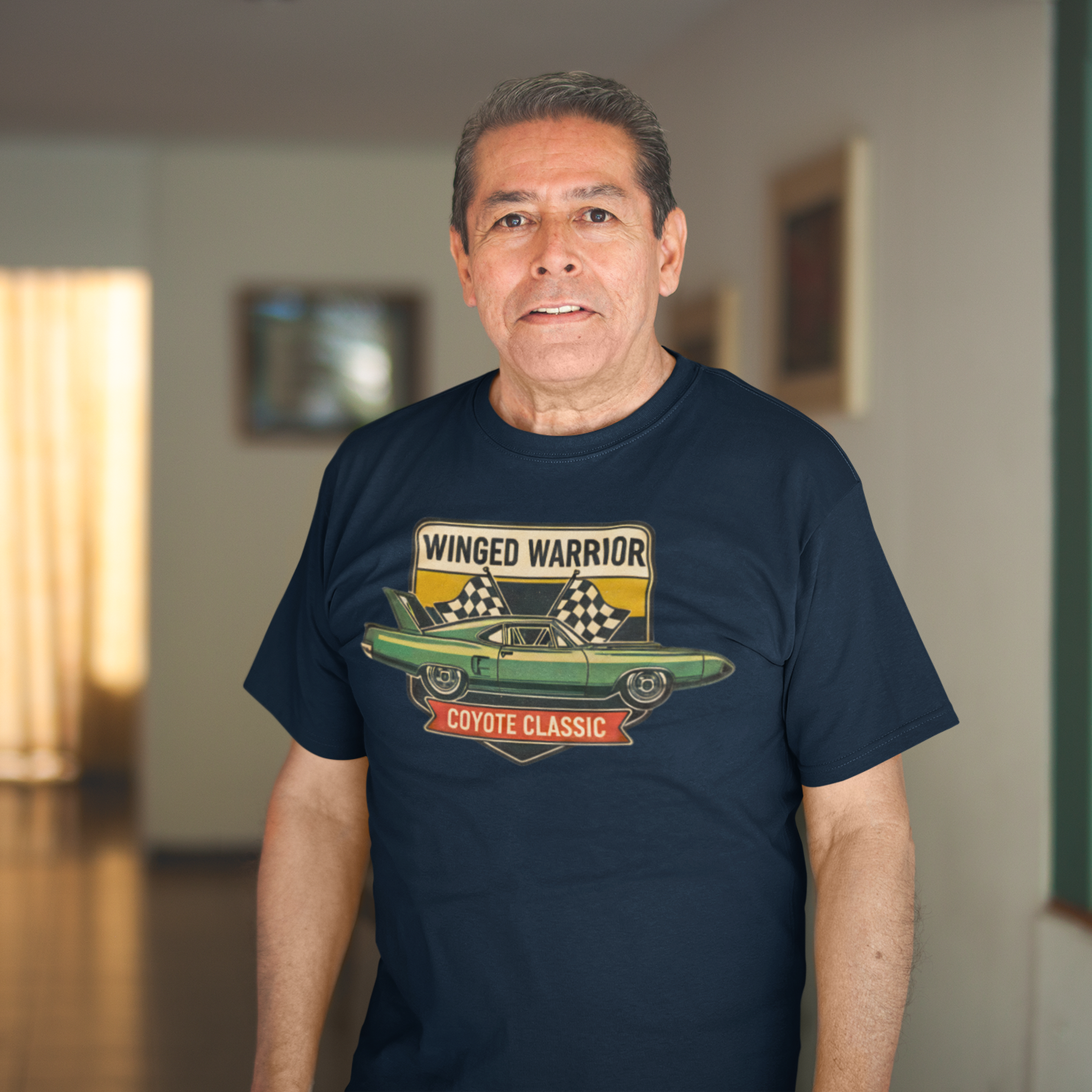 Man wearing a navy blue t-shirt with a graphic design in an indoor setting