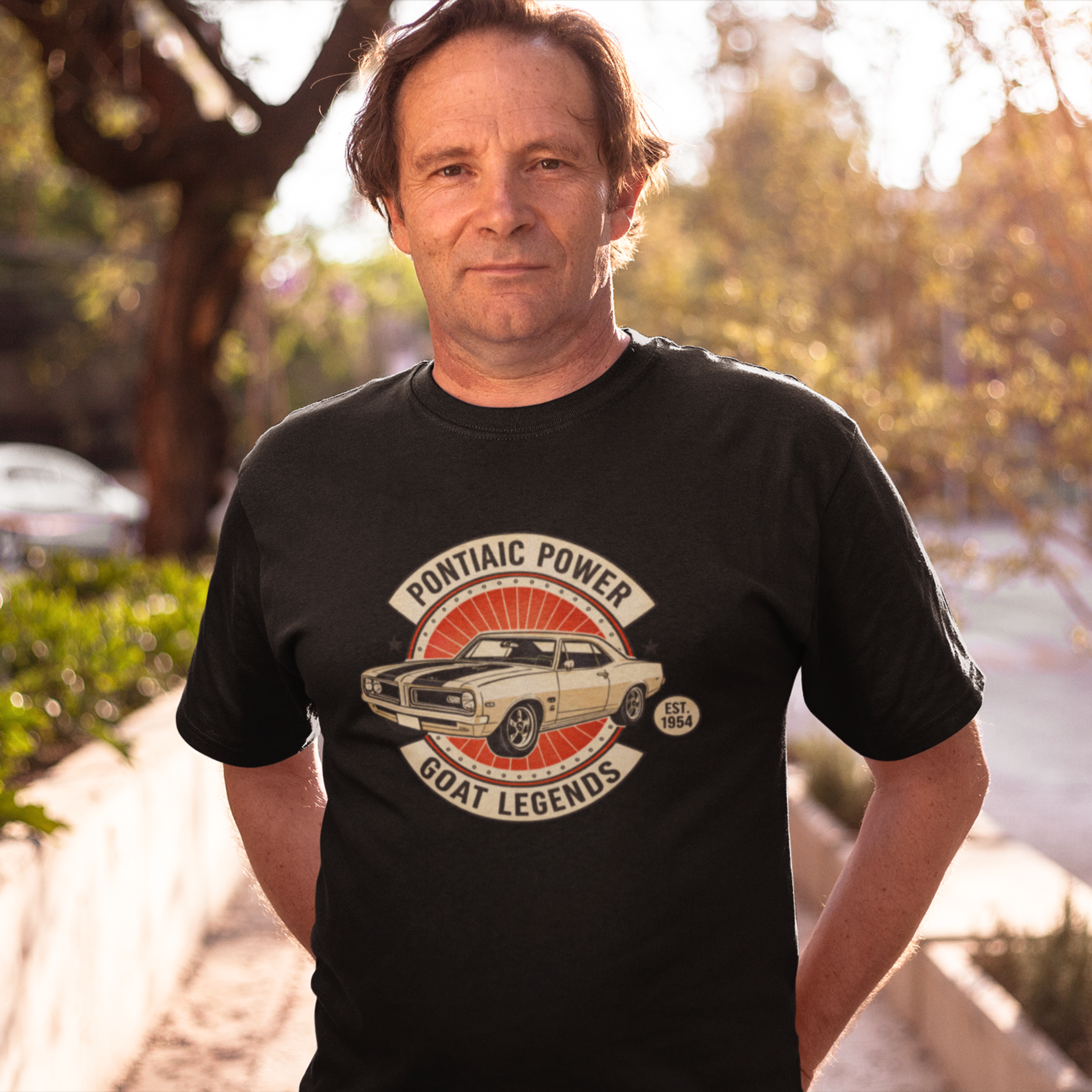 Man wearing a black t-shirt with a graphic design outdoors