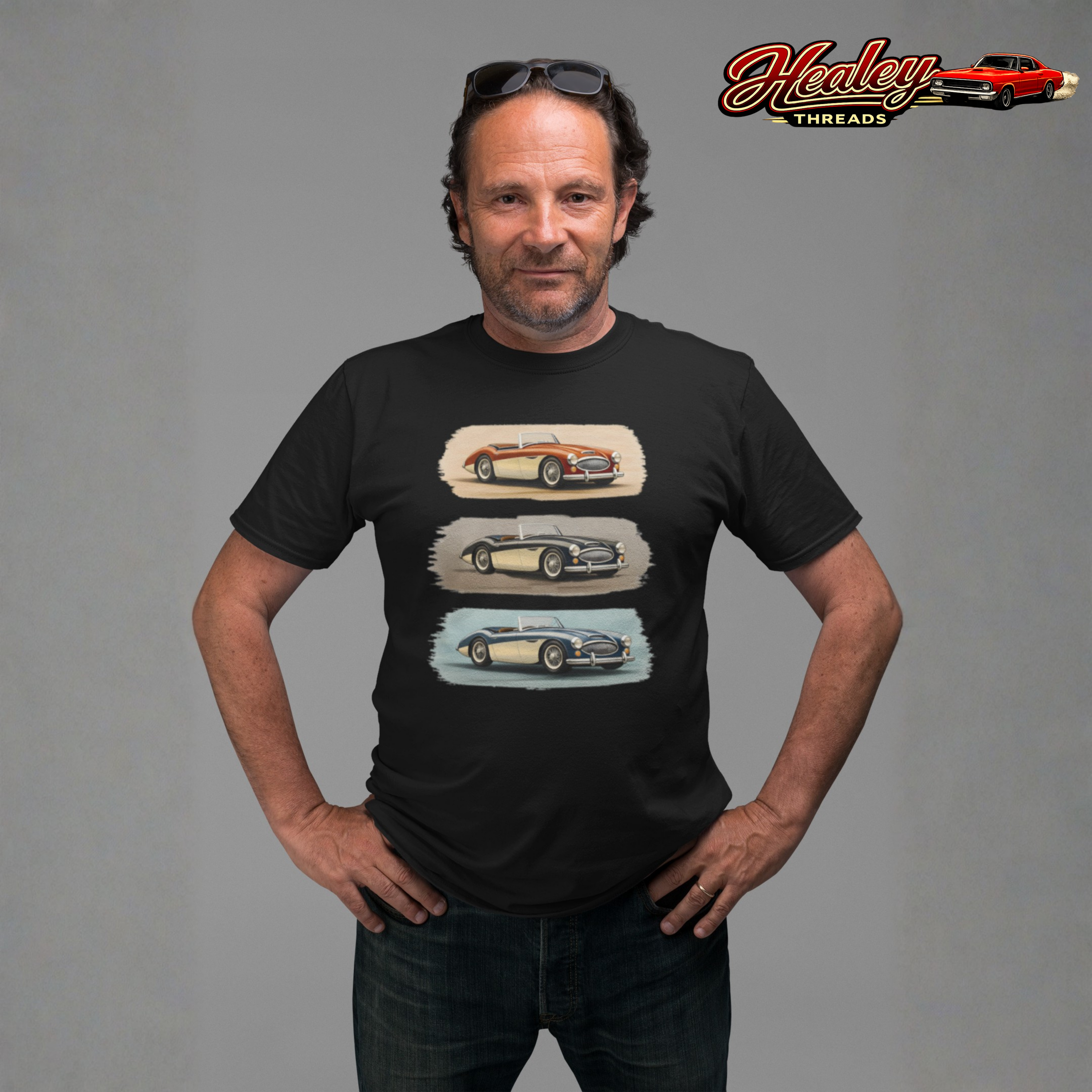 Man wearing a black t-shirt with vintage Healey car graphics on a gray background, featuring the 'Healey Threads' brand.