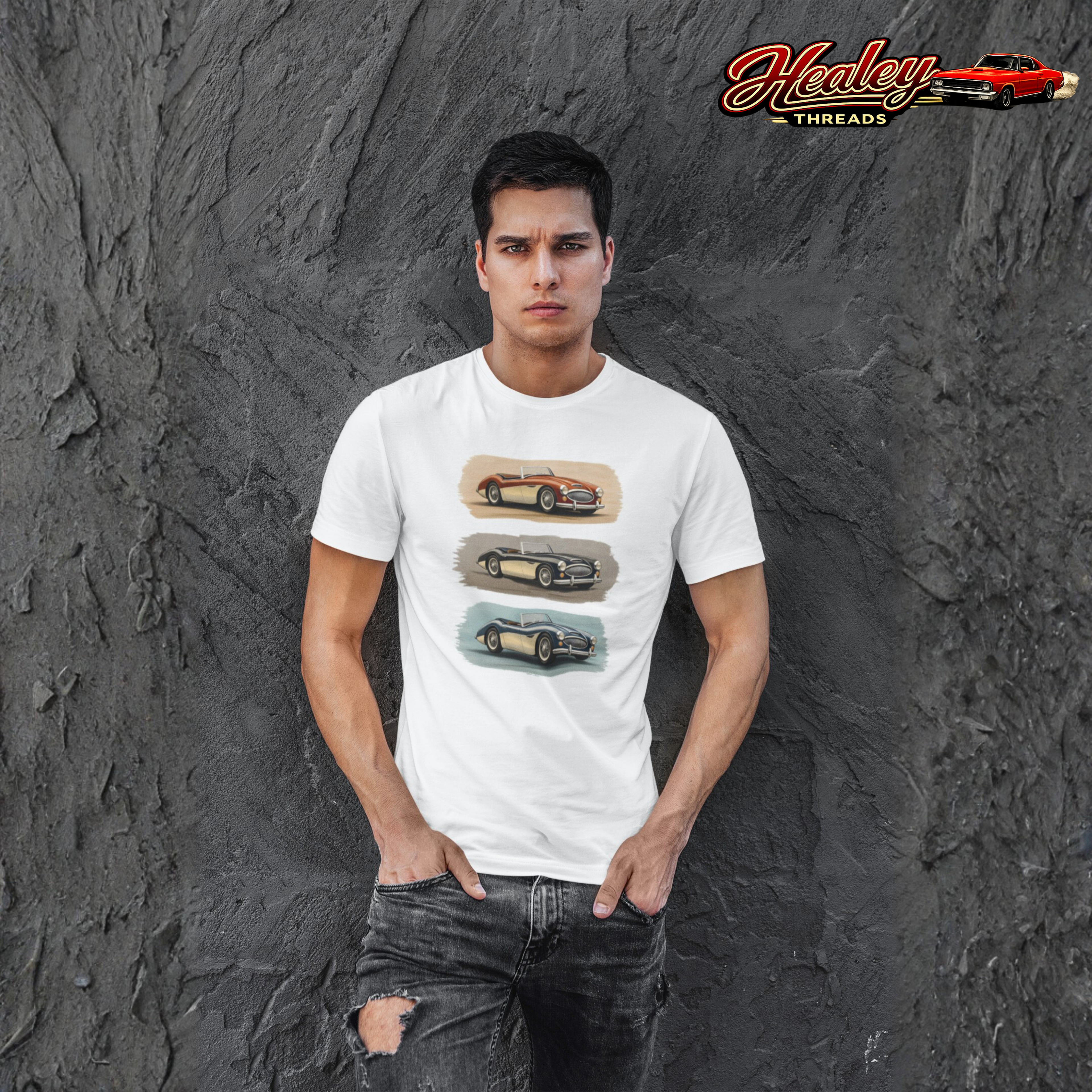 Man wearing a white Healey t-shirt with car graphics against a textured gray wall, featuring the 'Healey Threads' brand.