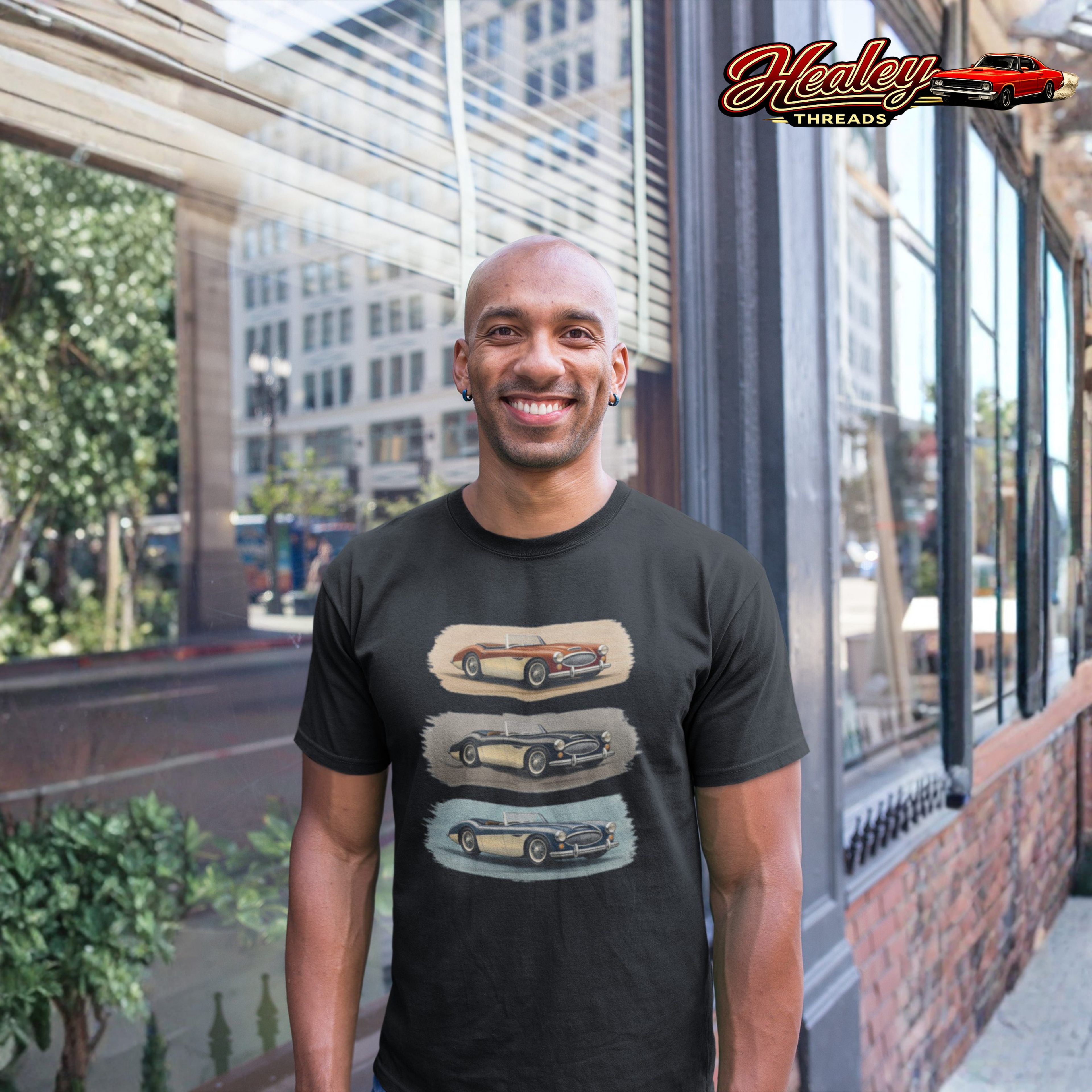 Man wearing a black Healey t-shirt with car graphics in an urban setting