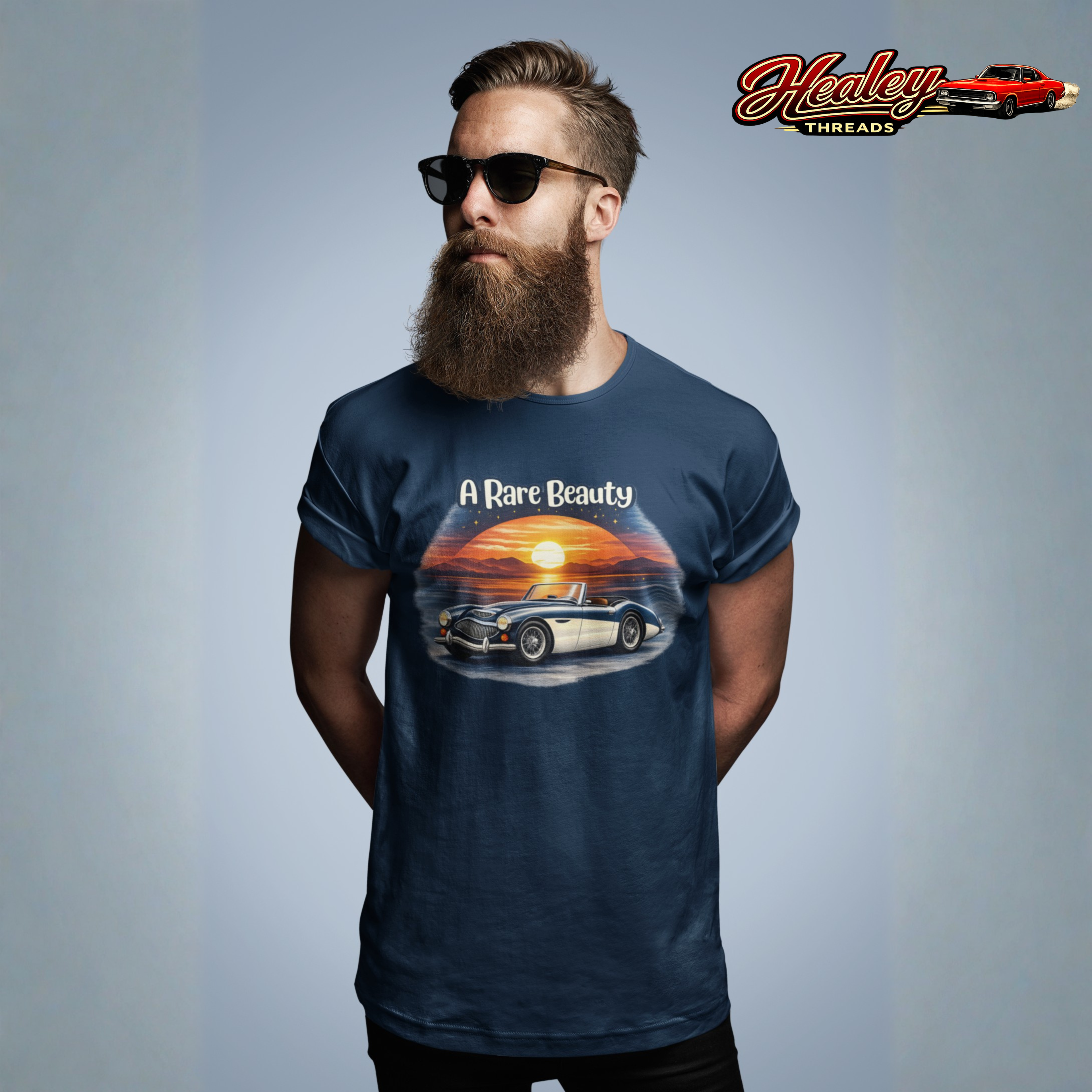 Man wearing a navy blue t-shirt with a Healey car graphic and 'A Rare Beauty' text, standing against a plain background.