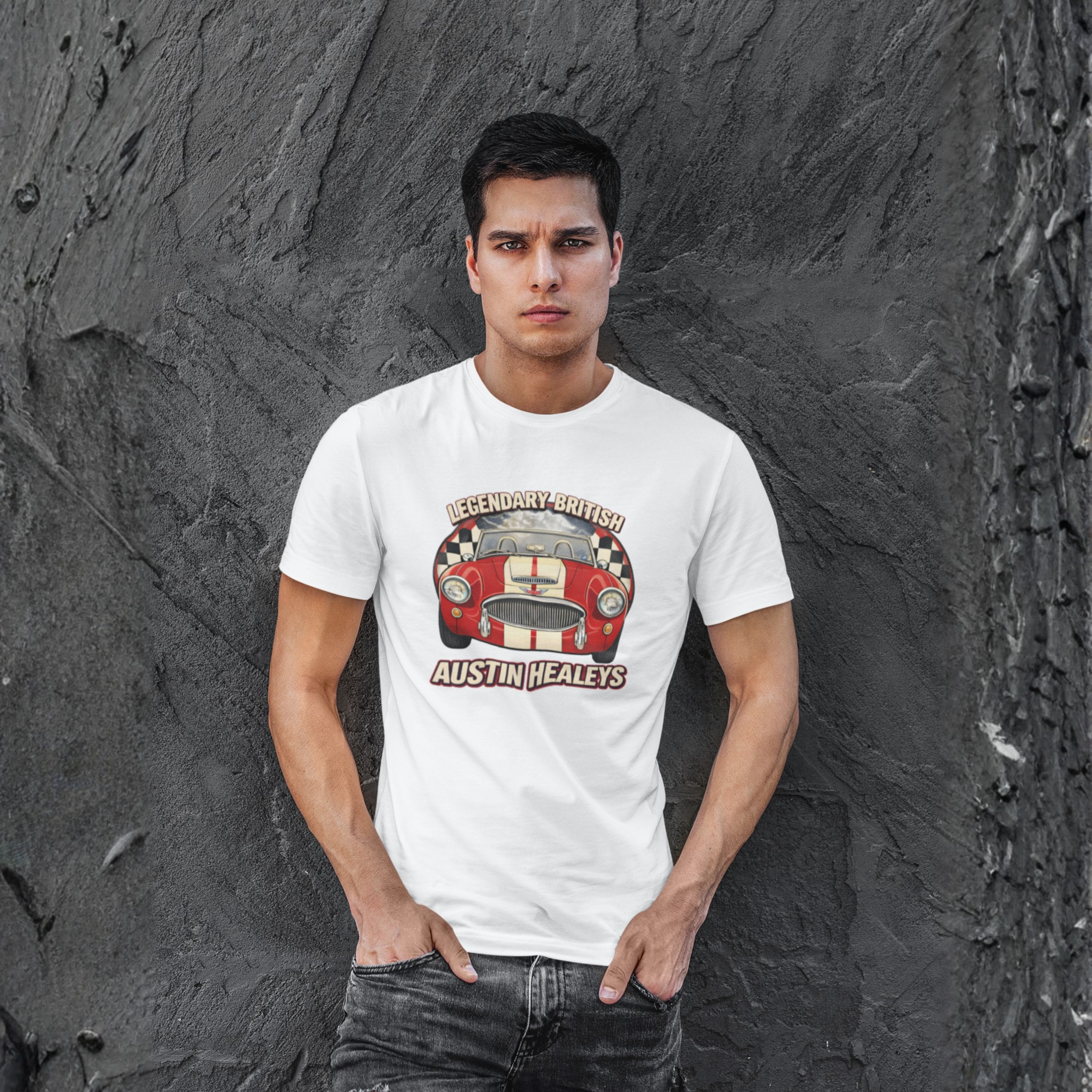 Man wearing a white t-shirt with a graphic Healey design against a textured gray wall