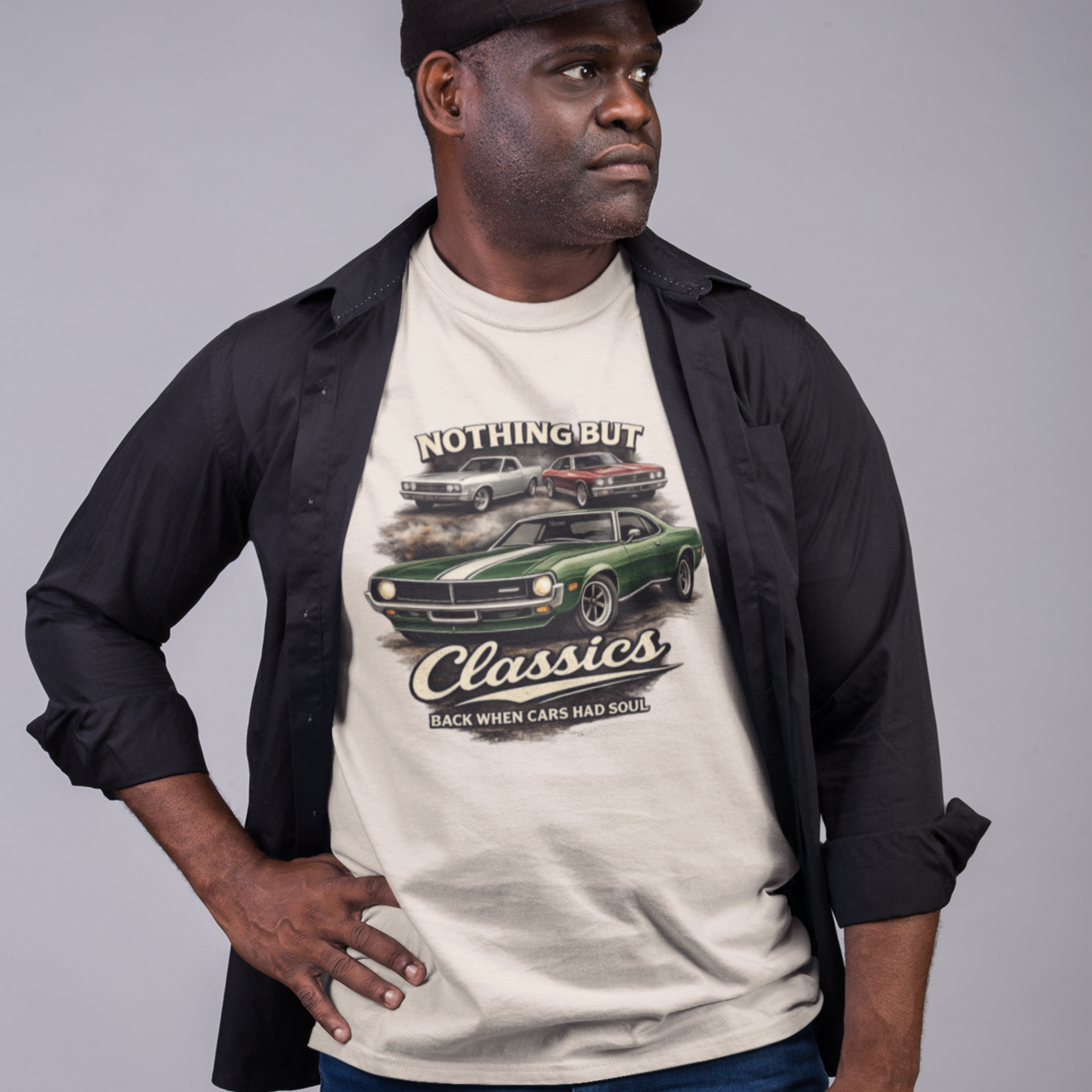 Man wearing a beige t-shirt with classic car graphic and text on a gray background