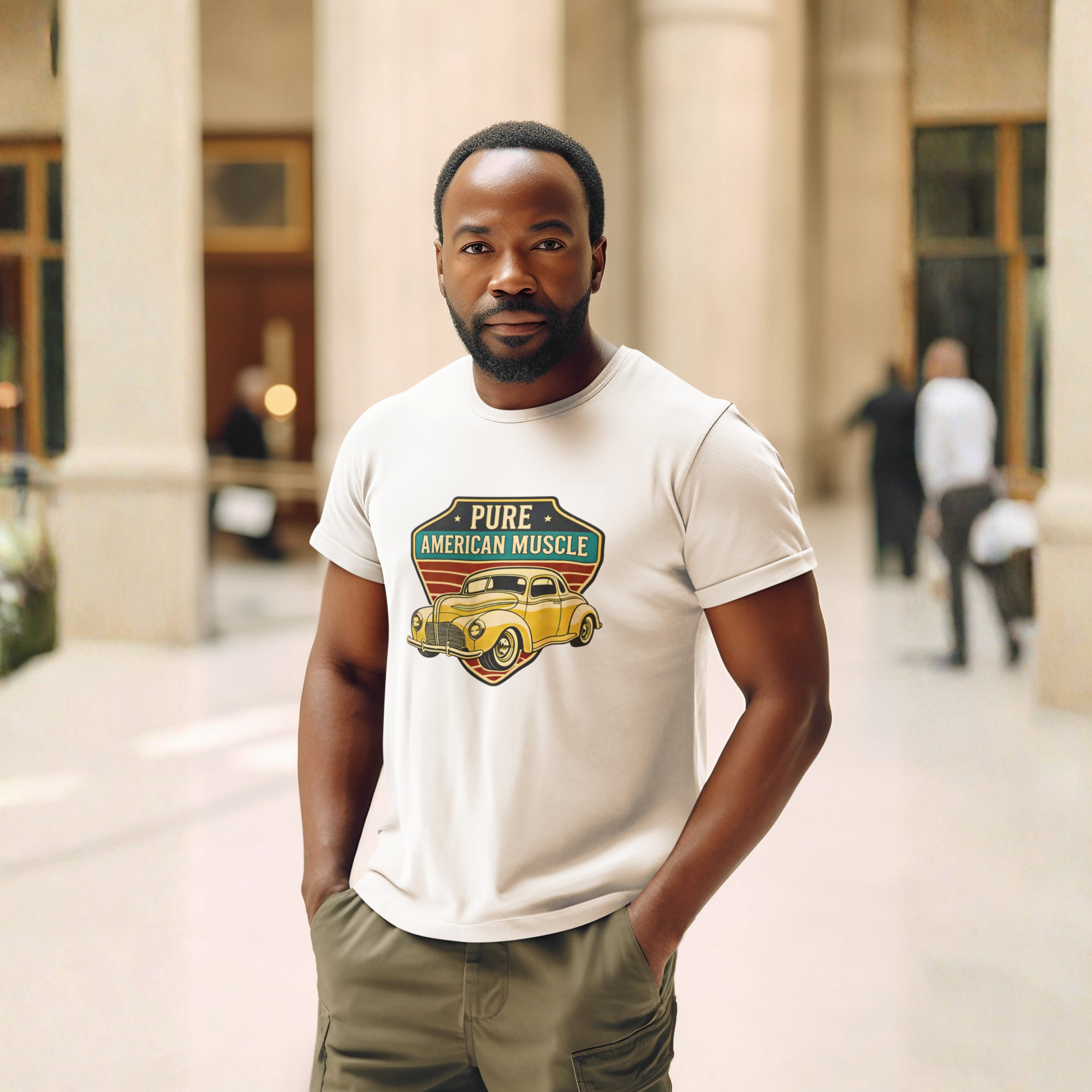 Man wearing a beige t-shirt with a graphic design standing in front of a building.