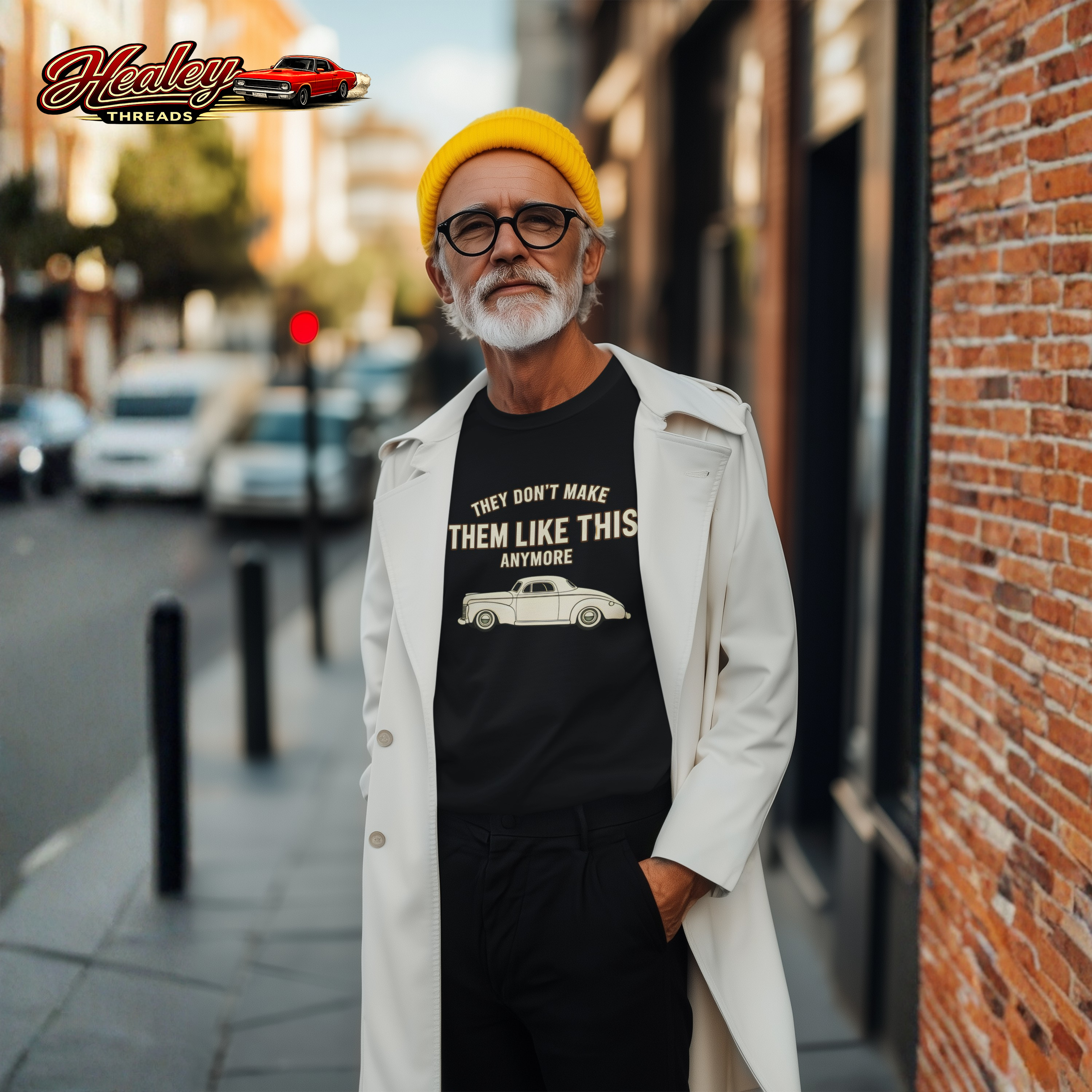 Man wearing a black t-shirt with a graphic and text, standing on a city street.