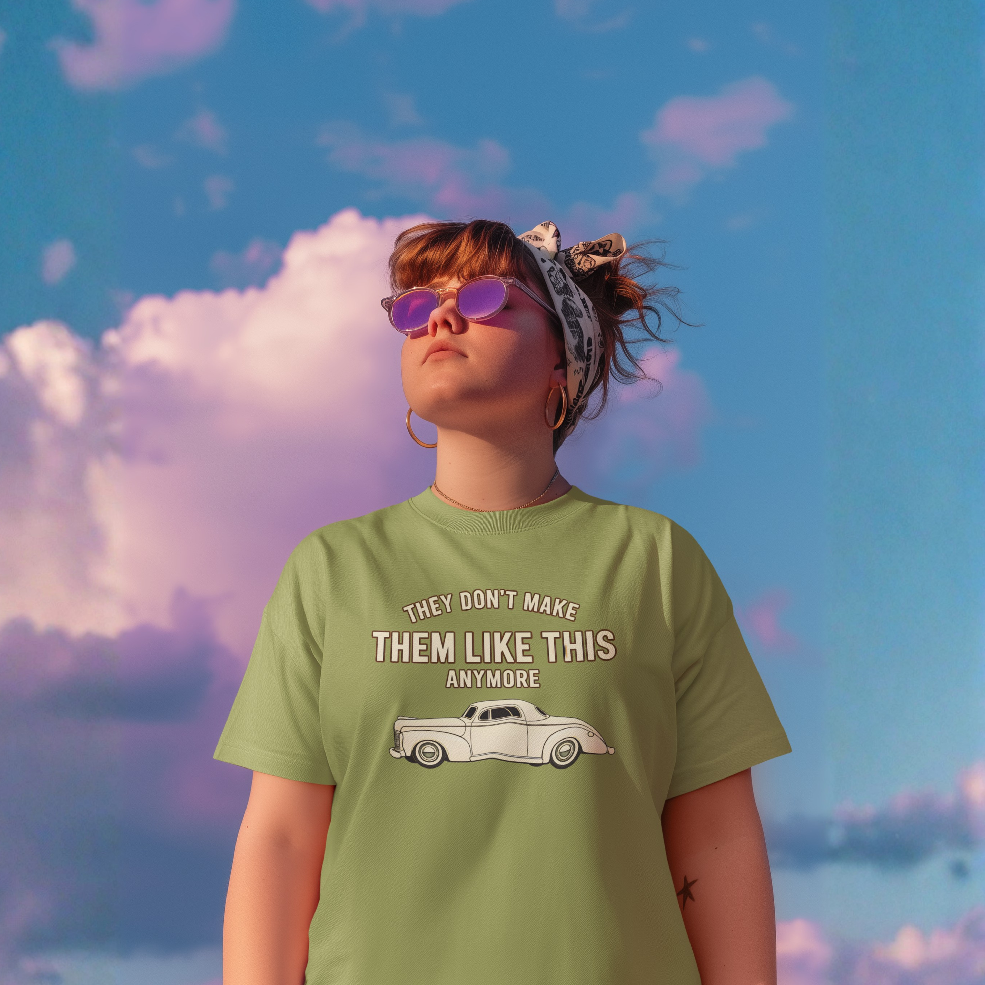 Girl wearing a military green t-shirt with a graphic and text against a colorful sky.