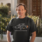 Man wearing a black t-shirt with a vintage hot rod graphic and text, standing outdoors.