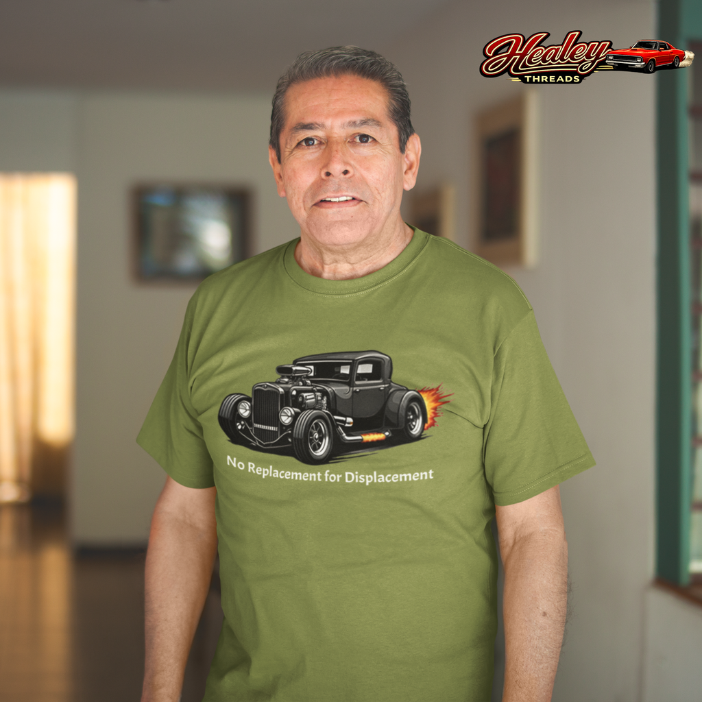 Man wearing a military green t-shirt with a hot rod graphic and text, standing indoors.