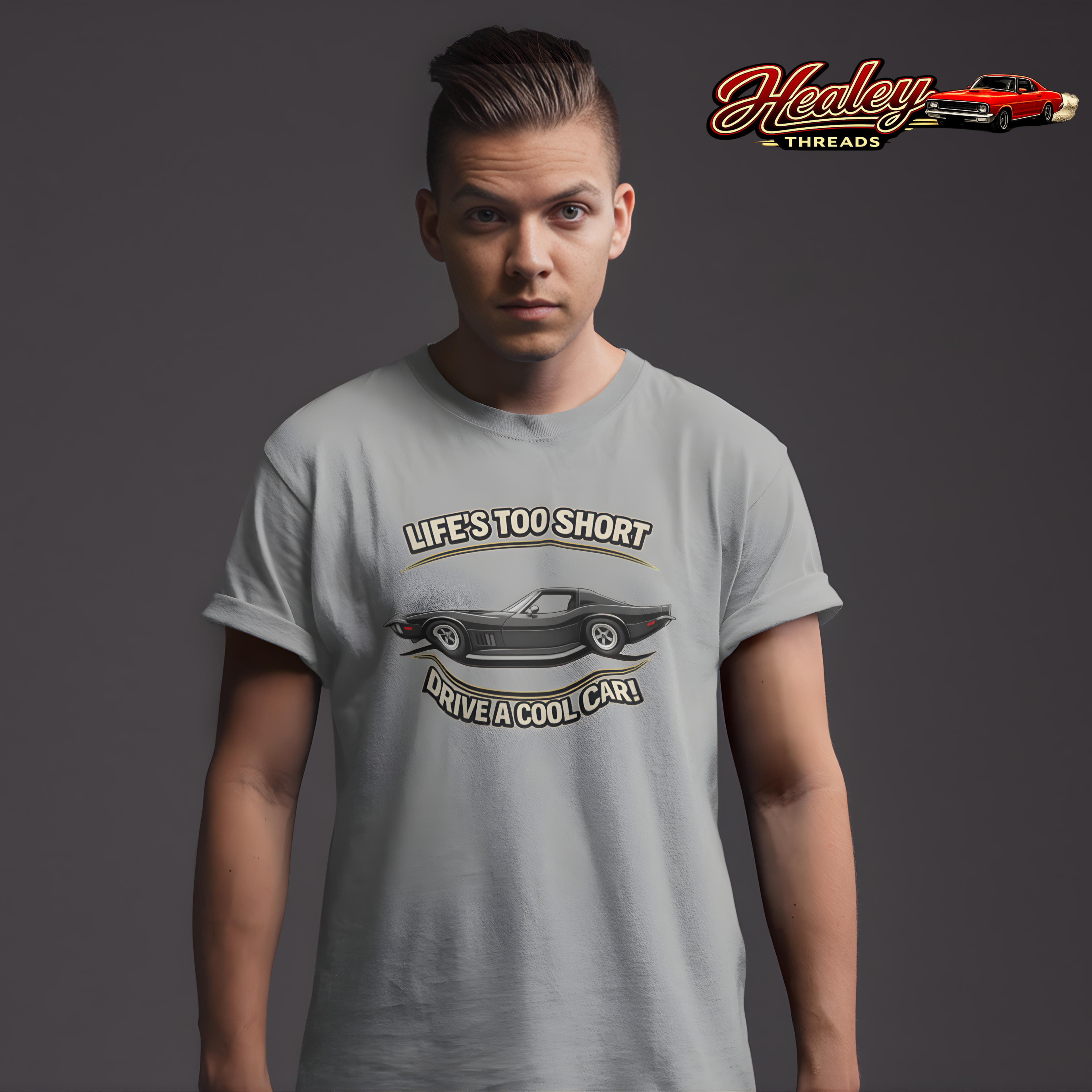 Man wearing a gray t-shirt with a vintage vette graphic and text, Healey Threads logo in the corner.