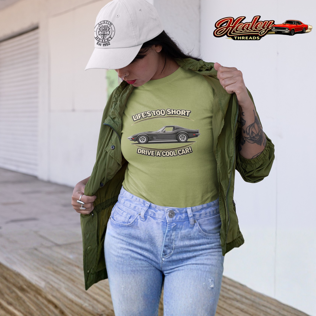 Woman wearing a green t-shirt with a vintage vette graphic and text, standing outdoors.