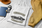 White t-shirt with vintage vette graphic and text on a white surface with accessories.